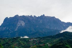 Kinabalu Mountain from villages at the foothill of the mountain view with clear of the cloud. photo