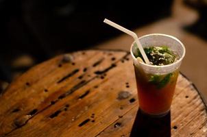 A glass of Mojito with mint leaf and sugar cane. photo