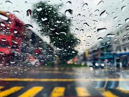 Water drop on car glass when raining at monsoon season photo
