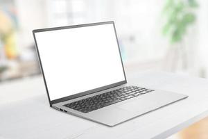 Laptop mockup on office desk. Isolated screen for web page promotion. Clean flat desk. Iluminated office in background photo