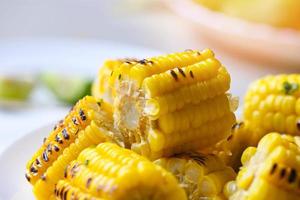 sweet corn food with salad vegetable, sweet corn cooked on plate background, close up ripe corn cobs grilled sweetcorn for food vegan dinner or snack photo