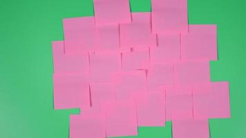 Many note paper on a green background - Stop Motion Animation. video