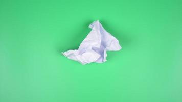 Stop motion VDO, paper ball unwrapping on green background. video
