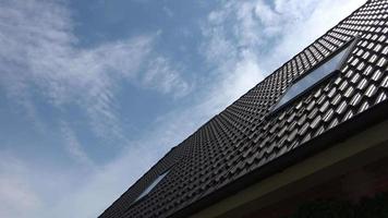 Time lapse of roof window with velux style windows and clouds passing by video