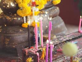 Colorful Yellow candles lit on the candle holder at temple, candlelight photo