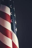 Standing flag United States of America on dark gray background.Banner of America in retro style. photo