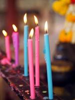 Colorful Yellow candles lit on the candle holder at temple, candlelight photo