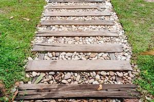 pebble floor and wooden walkway in garden photo