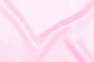 Plastic pink satin fabric texture soft blur background photo