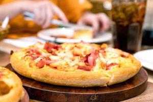 Pizza on wooden table in restaurant photo