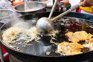 Thai oyster omelet or hoy tod on street food market photo