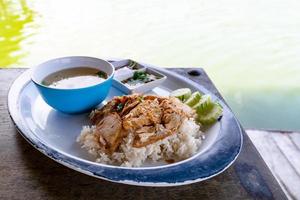 roasted pork with rice at river side photo