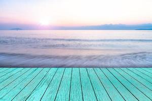 top wooden desk with blur summer sea at sunset and copy space,sky relaxing concept,beautiful tropical background for travel landscape photo