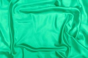 green satin fabric texture soft blur background photo