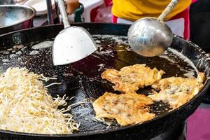 Thai oyster omelet or hoy tod on street food market photo