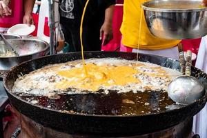 Thai oyster omelet or hoy tod on street food market photo