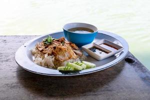 roasted pork with rice at river side photo