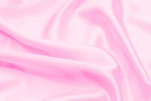 Plastic pink satin fabric texture soft blur background photo