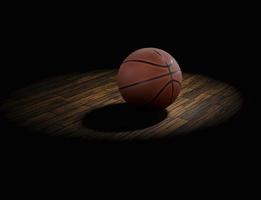 pelota de baloncesto en el parquet con fondo negro foto