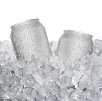 Cans with water droplets and ice on ice cubes Isolated on white background photo