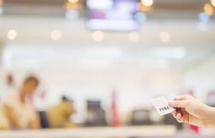 Man is holding queue card while waiting in the modern reception area photo