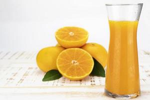 Fresh orange juice fruit drink glass over white background - tropical orange fruit for background use photo