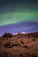 Aurora borealis in the starry night of Iceland, vertical shot. photo