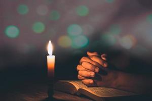 manos de mujer rezando en la sagrada biblia