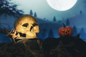 Spooky cemetery with glow halloween pumpkin photo