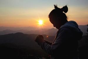 woman worship on sunset photo