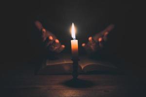 Woman hands praying on holy bible photo