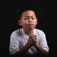Boy praying to God at home photo