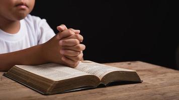 Boy praying to God at home photo