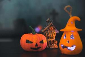 Spooky cemetery with glow halloween pumpkin photo