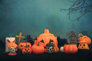 Spooky cemetery with glow halloween pumpkin photo