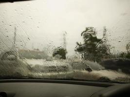 Windshield wipers from inside of car, season rain. traffic jam. photo