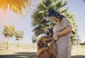 Pregnant woman with dog photo