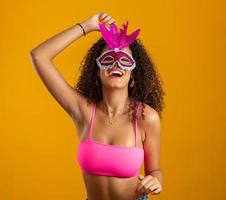 Beautiful woman dressed for carnival night. Smiling woman ready to enjoy the carnival with a colorful mask. photo