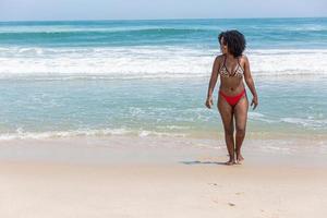 Black afro young cute girl, curly hair, bikini, beach. Afro American summer vacation holiday. photo