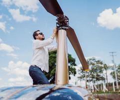 Male mechanic or pilot examining helicopter. Pre flight inspection at the helipad photo