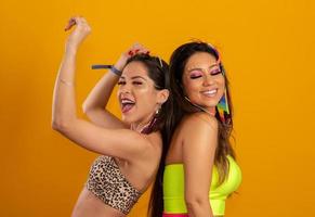 Brazilian Carnival. Two young women in costume enjoying the carnival party. Friends. photo