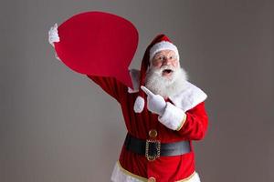 Santa Claus holding blank text balloon. photo