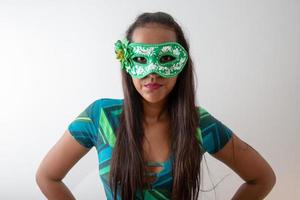 happy young woman with mask and confetti at carnaval party. Brazilian Carnival photo