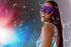 happy young woman with mask and confetti at carnaval party. Brazilian Carnival photo