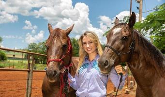 Beautiful woman and two horse photo