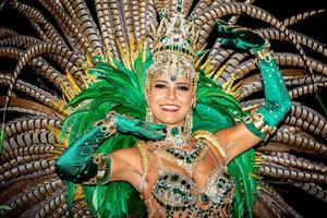 Brazilian wearing Samba Costume. Beautiful Brazilian woman wearing colorful costume and smiling during Carnaval street parade in Brazil. photo