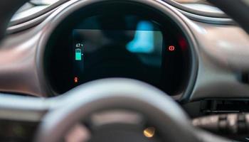 Electric car dashboard showing battery percentage. photo