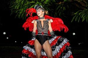 Brazilian wearing Samba Costume. Beautiful Brazilian woman wearing colorful costume and smiling during Carnaval street parade in Brazil. photo