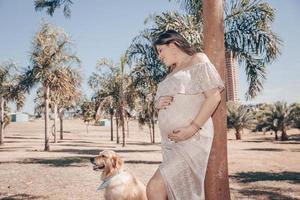 Pregnant woman with dog photo