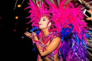 Brazilian wearing Samba Costume. Beautiful Brazilian woman wearing colorful costume and smiling during Carnaval street parade in Brazil. photo